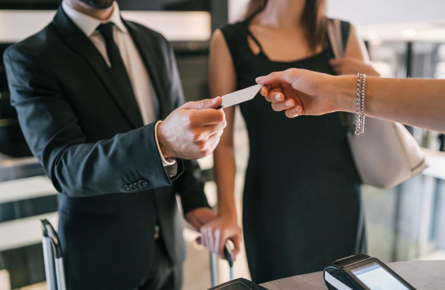 Guest receiving a hotel keycard at a contactless check-in point in Dubai